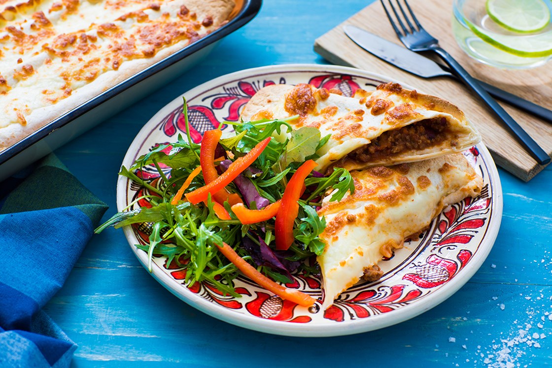 Enchilada fyllt med chili con carne, salat og salsa