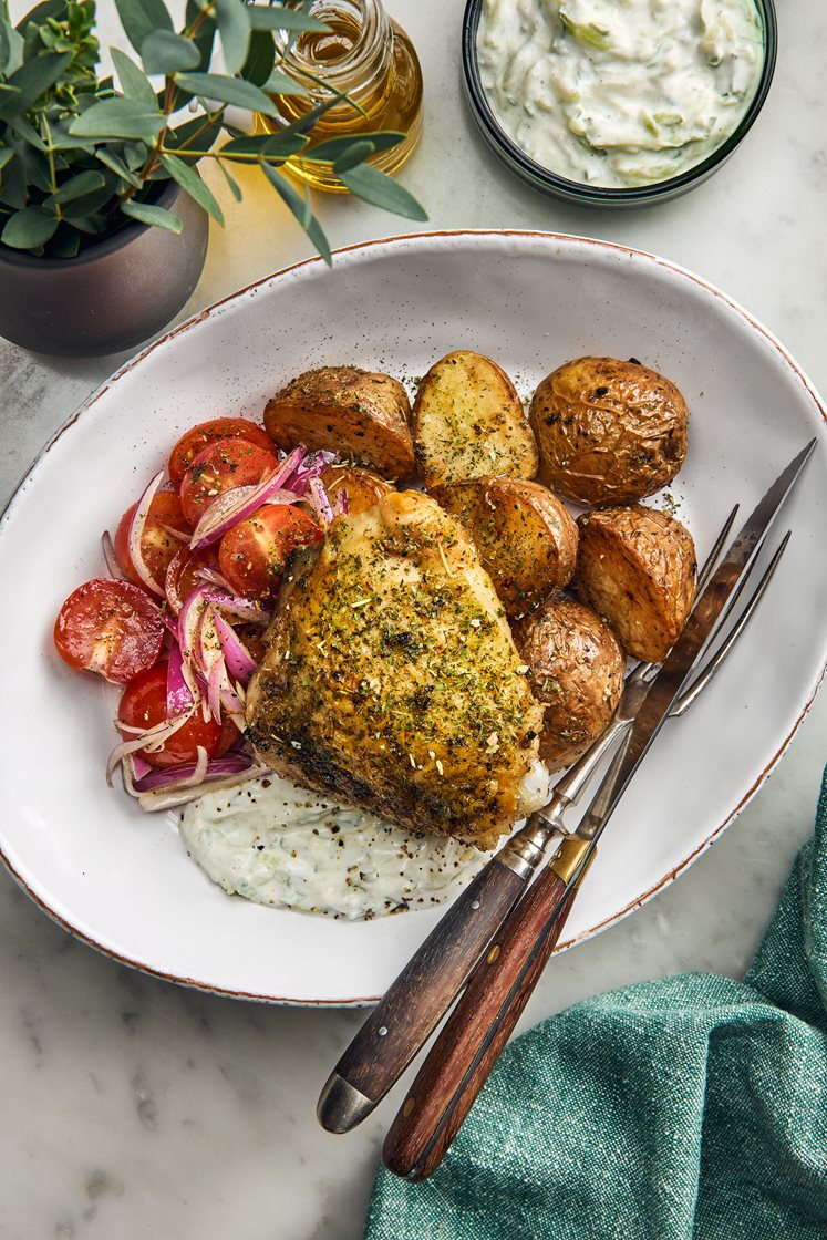 Kycklinglår på ben med örttäcke, rostad potatis, tzatziki och tomatsallad