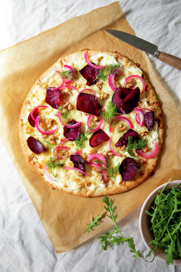 Hvit pizza med rødbeteskiver, valnøtter, syltet rødløk og dill