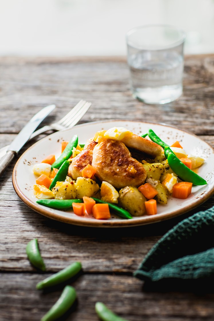 Fiskekaker med knuste poteter, eggesmør og kokte gulrøtter og sukkererter