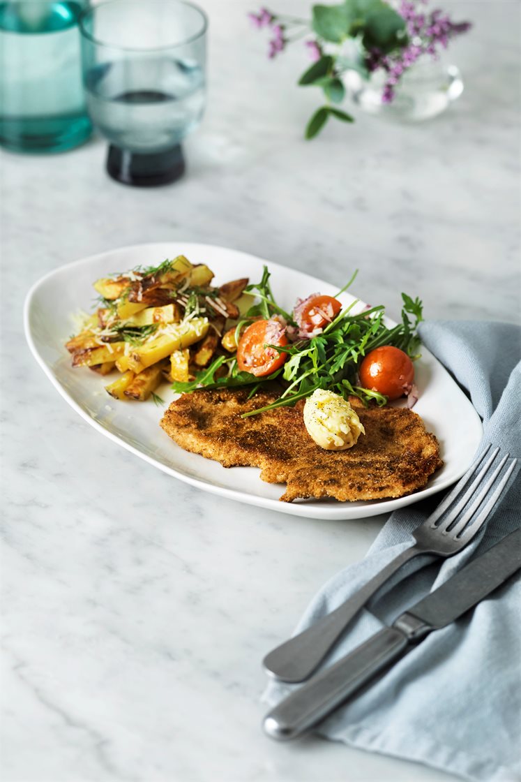 Kycklingschnitzel med dill- och parmesanpommes, kryddsmör och tomatsallad