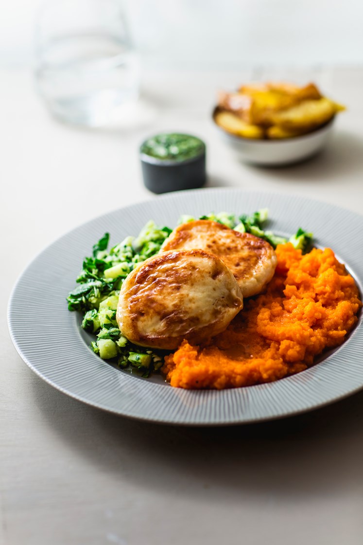 Fiskekaker med gulrotpuré, ovnsbakte potetbåter og salat servert med koriander- og limevinaigrette