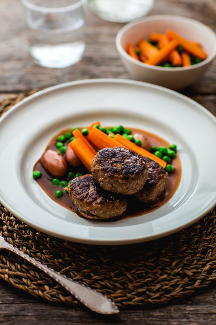 Medisterkaker og gulrøtter med erter, brun saus og småpoteter