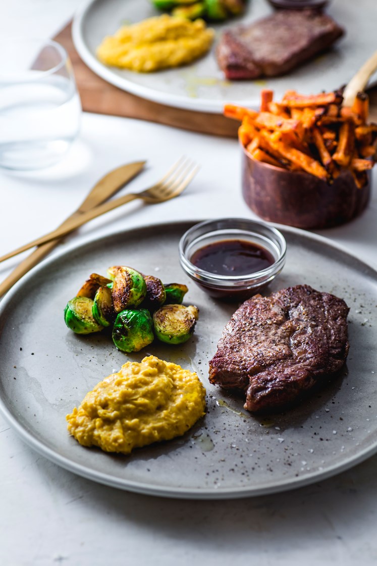 Minuttbiff av storfe med maiskrem, bakte søtpotetstaver og rødvinssaus